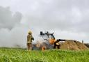Firefighters tackle the burning telehandler
