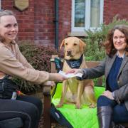 Lisa Moore, Show Manager, Devon County Show, presents Chloe Hammond with £1,000 towards the upkeep of her assistance dog, Ocho.
