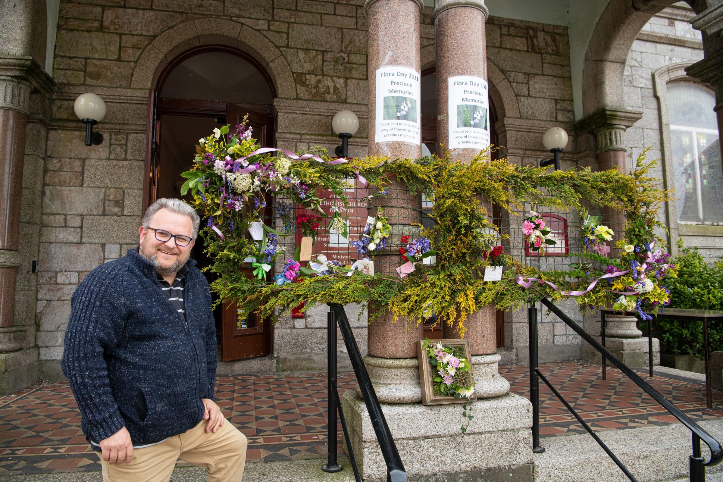 Rev Danny Reed has created a floral memory board outside the Central Methodist Church. Picture: Kathy White