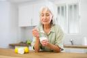 Woman eating a yoghurt. Stock image.