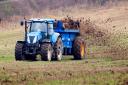 A farmer spreading fertiliser on a field in North Yorkshire.