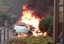 The car erupts into a fireball moments after the occupants got out. Picture: Liz Earl