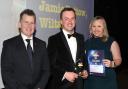 One of last year’s Young Farmers’ Club Achiever Awards winners, Jamie Pottow, from Wiltshire, centre, who won the Aspiring Rural Leader Award, is pictured with NFYFC president Nigel Owens MBE and Sarah Jackson, Head of Rural Professional at Savills,