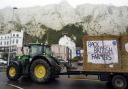 Farmers using their vehicles to protest against cheap meat imports drive past the Port of Dover in Kent.