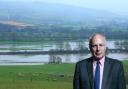 MP Ian Liddell-Grainger, with a flooded farm behind him.
