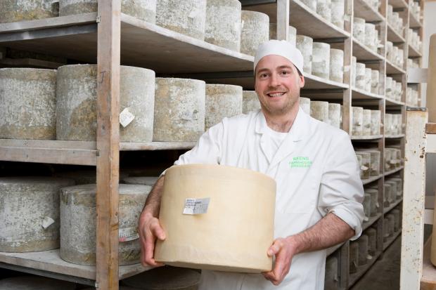 James Keen holding Keens Cheddar Cheese