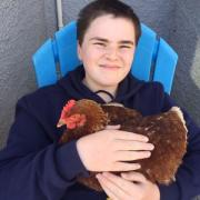 George smiled and made happy sounds whenever he saw chickens, so the family adopted five