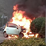 The car erupts into a fireball moments after the occupants got out. Picture: Liz Earl