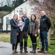 Clare James and her colleague Sam Briant-Evans with new tenant farmer Ollie White and his partner Charlotte and daughter Poppy