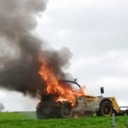 The telehandler on fire at Oliver's family's farm