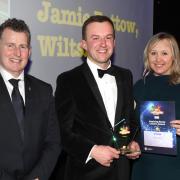 One of last year’s Young Farmers’ Club Achiever Awards winners, Jamie Pottow, from Wiltshire, centre, who won the Aspiring Rural Leader Award, is pictured with NFYFC president Nigel Owens MBE and Sarah Jackson, Head of Rural Professional at Savills,