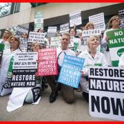 TV presenter and environmentalist Chris Packham (centre) with scientists protesting outside the offices of the Department for Environment, Food & Rural Affairs (Defra) in central London.