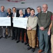 Some members of the club with the cheques for the charities