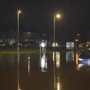 The scene at midnight in Wiltshireon the Bradford Road and Brook Road roundabout with cars stuck in the flood water.