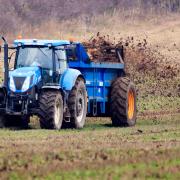 A farmer spreading fertiliser on a field in North Yorkshire.