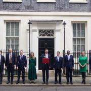 Chancellor of the Exchequer Jeremy Hunt (centre) poses with his ministerial box and members of his Treasury staff, prior to delivering the budget.