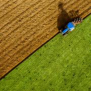 Tractor ploughing a field, stock image.