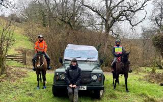 Amanda Hamley Chairperson of West Somerset & Exmoor Bridleways Association with fellow rider Sam, presenting a big cheque (shown on the ENPA vehicle) to Ranger Charlotte Wray.