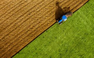 Tractor ploughing a field, stock image.